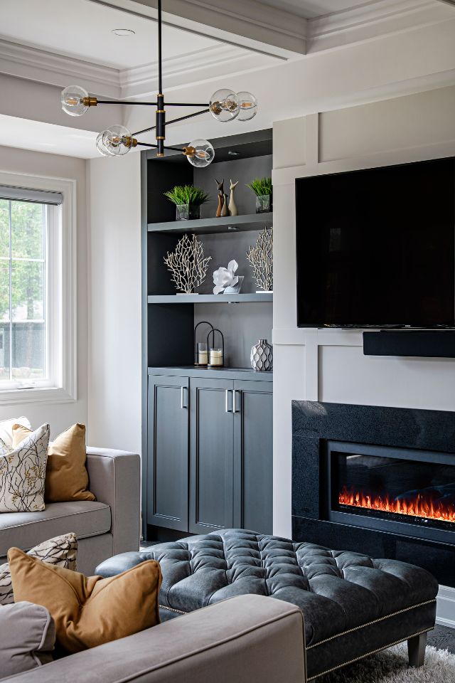 designer home with black bookshelves, black fireplace and black detailing